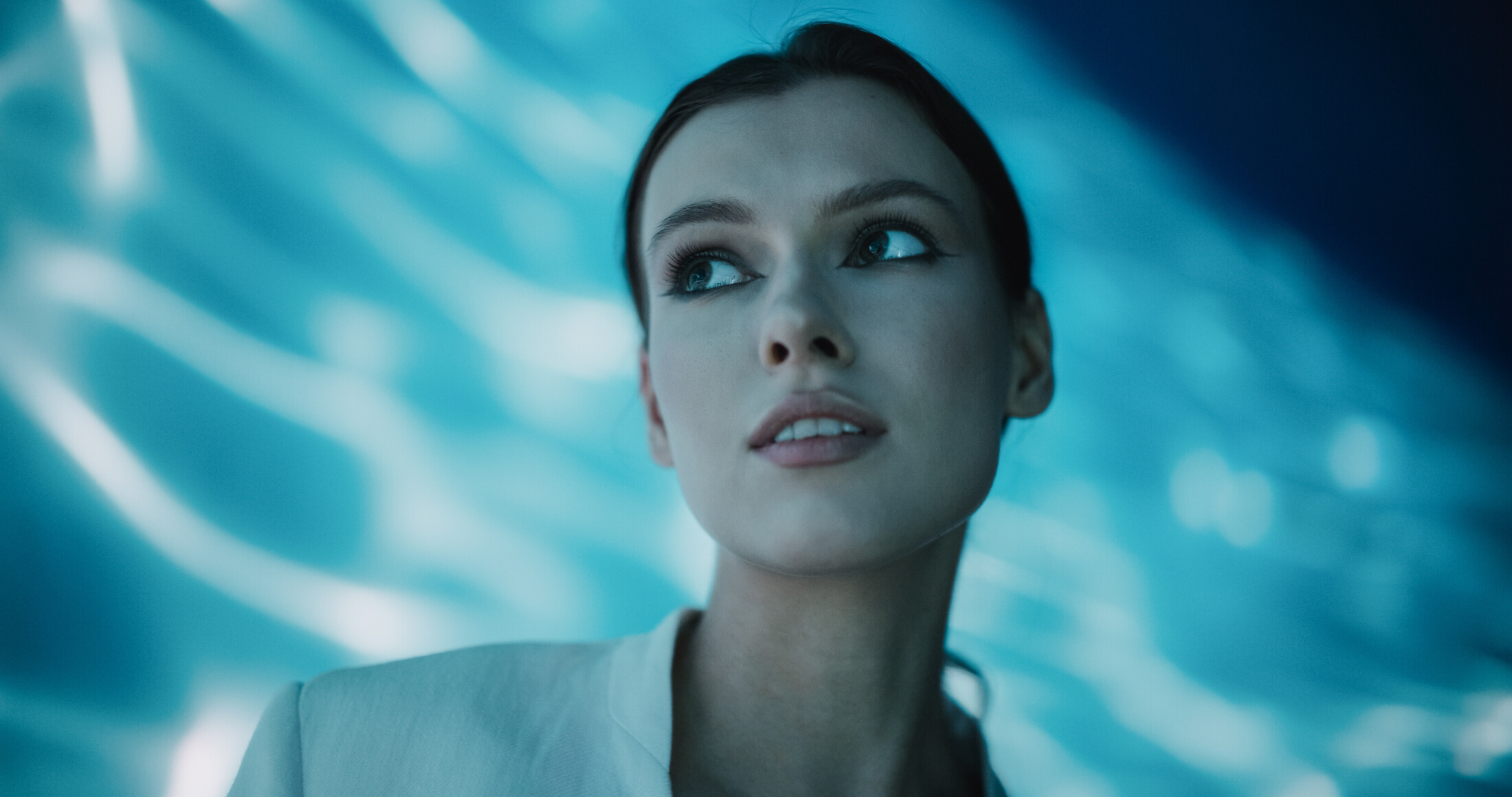 Woman Looking Up Blue Background Water Reflection Simple Model Adobe Stock 635817310 (1)