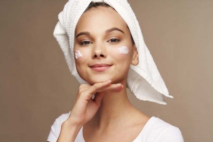 Cute Brunette Towel On Hair Dots Of Lotion On Cheeks Cute Adobe Stock 338984115