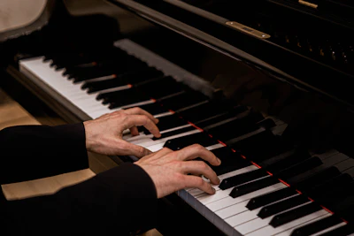 Pianist's hands playing a grand piano during a classical music performance